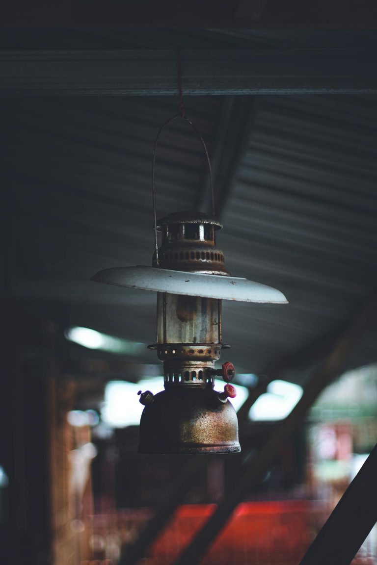 A close-up of an old-fashioned kerosene lamp hanging from a ceiling, exuding nostalgia.