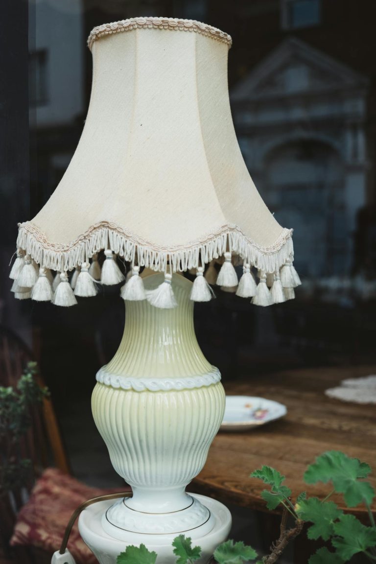 A vintage table lamp with ornate tassels adds charm to any home decor.