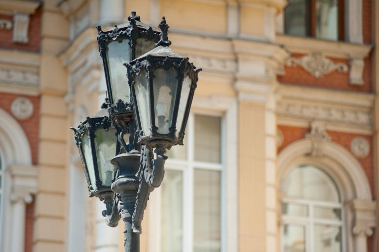 Classic street lamp against a detailed architectural background.